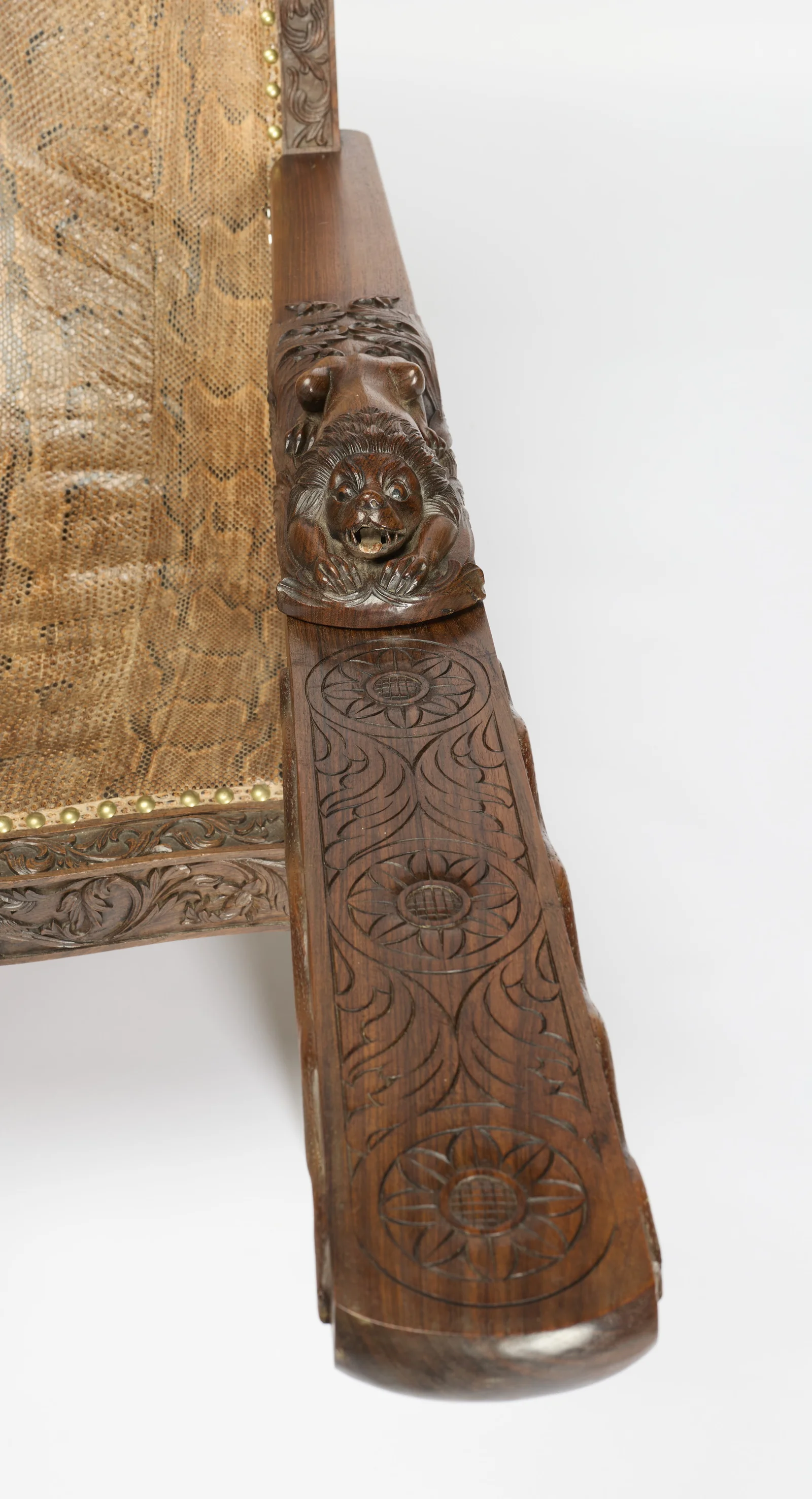 The board's rounded end and wave-carved edge, with the bird-carved seat rail beyond.