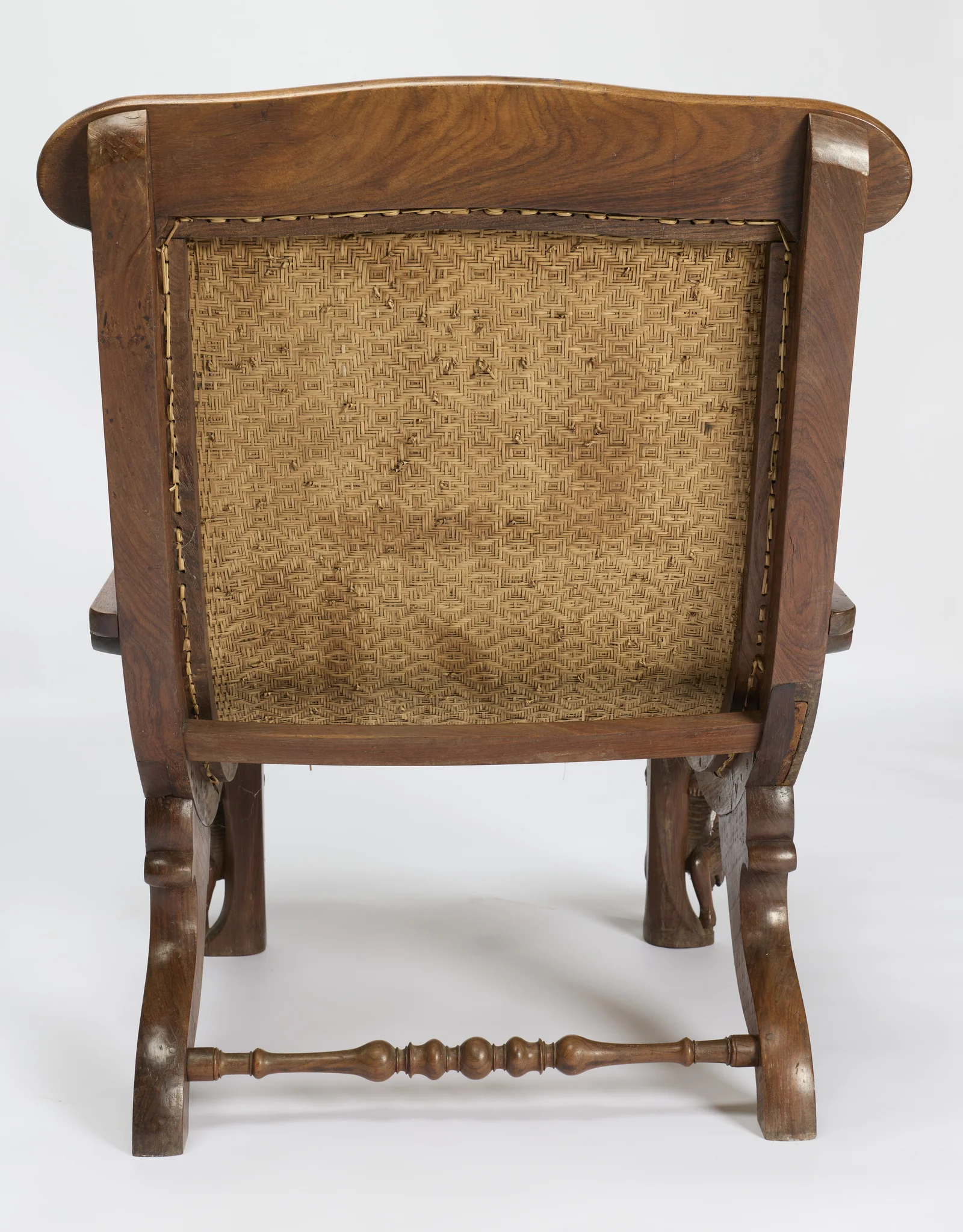 A woven cane panel in a diaper pattern is tied through the back frame, the shaped rear legs joined by a ball-turned stretcher.