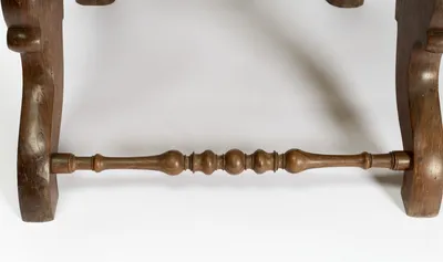 Ball and ring turning spans the shaped rear legs beneath the seat.