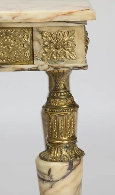 A square gilt block of layered leaves and berries beside an embossed panel of berried lattice-work.