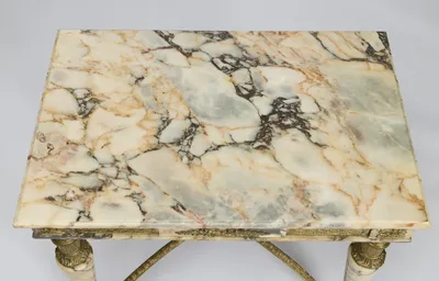 A cream ground broken by grey, rust and blush veins, the edge cut with a shallow bevel.