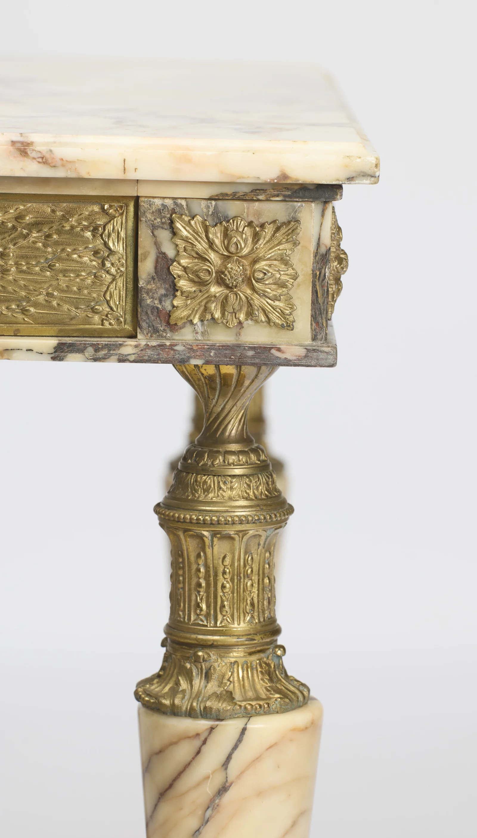Rosette blocks turning the corner of the frieze above the twisted cup at the head of the leg.