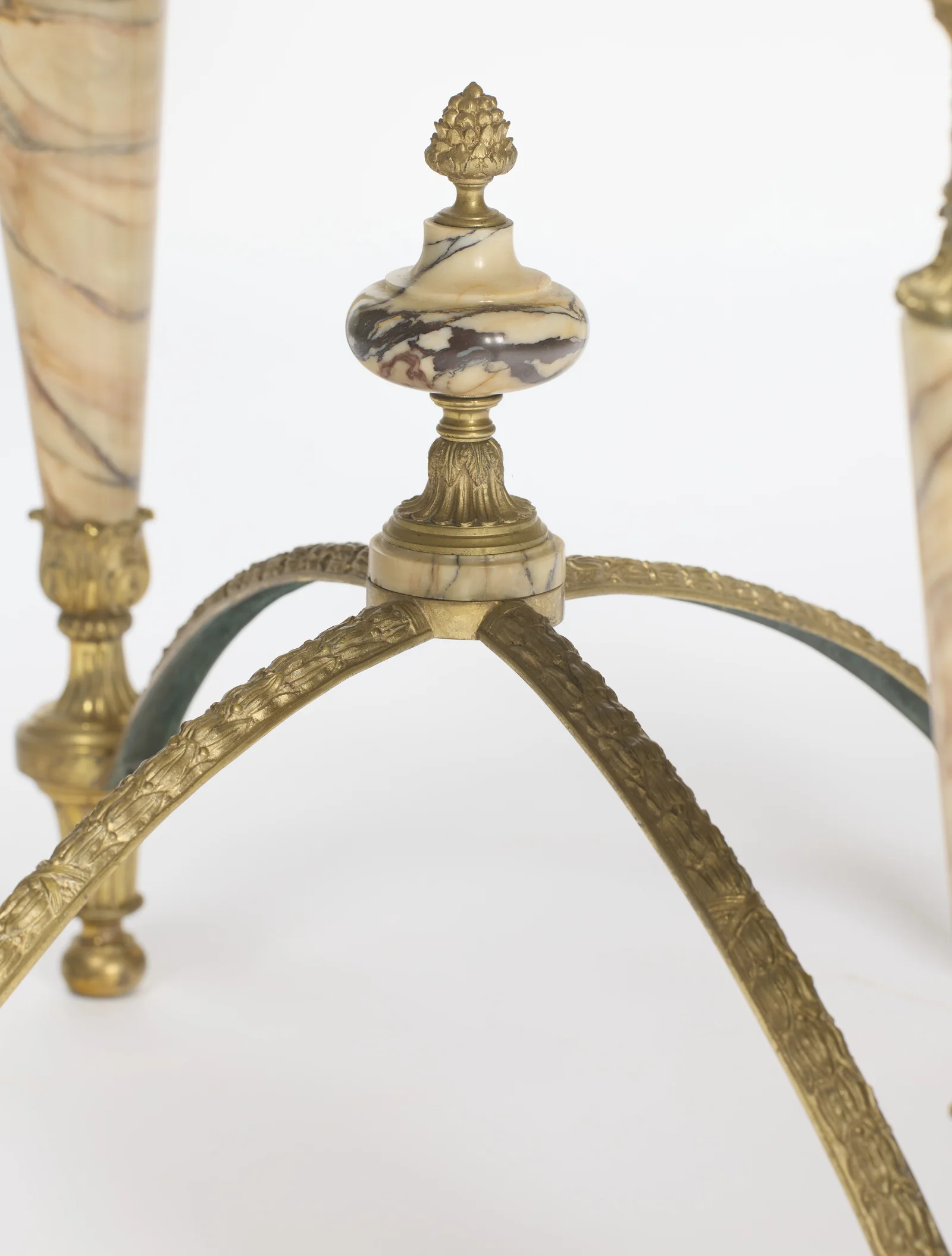 Four leaf-cast arms rising to meet beneath the veined marble knop and its gilt pinecone top.