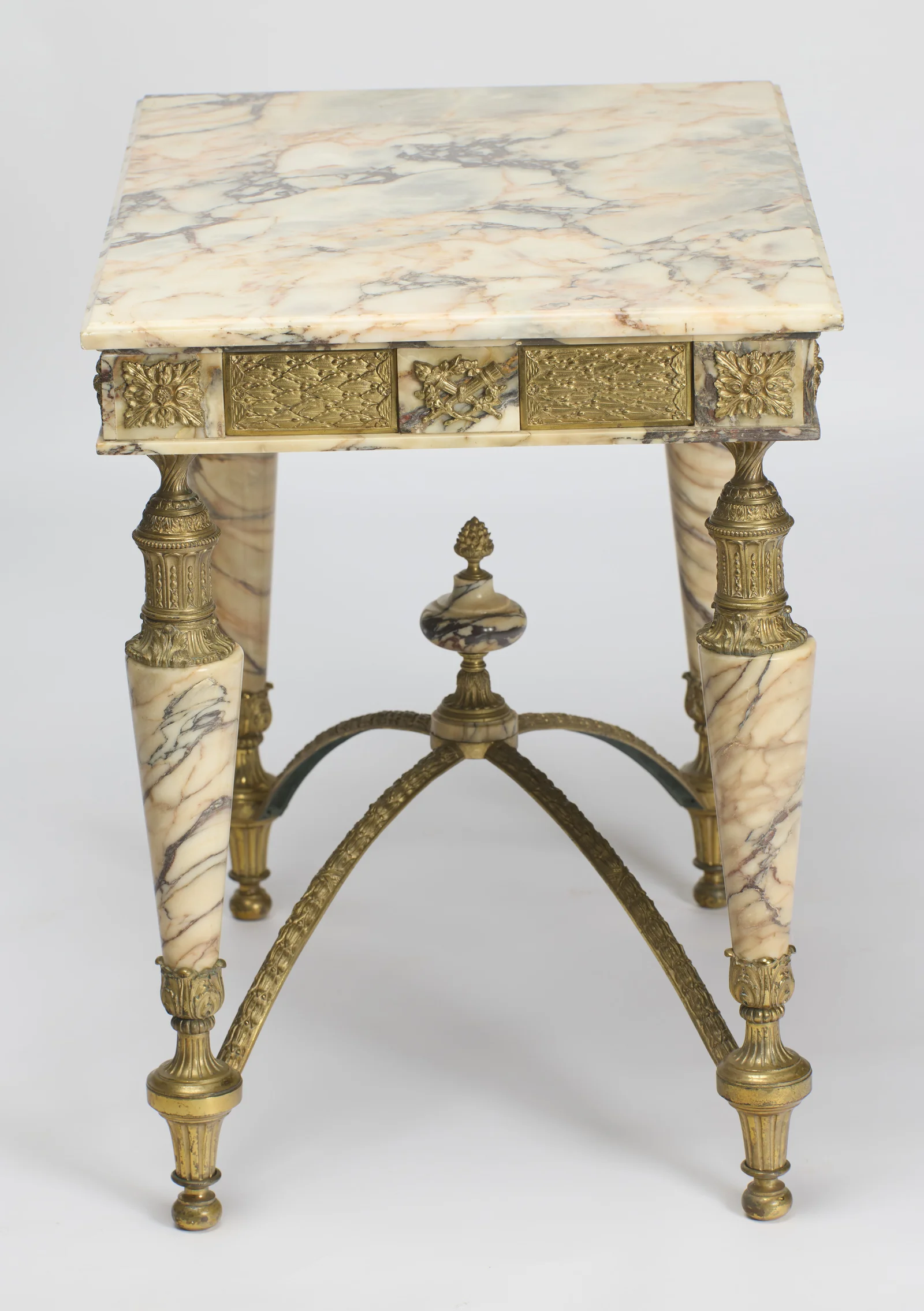 The veined top and the end frieze together, a small trophy mount centred between berried lattice panels.