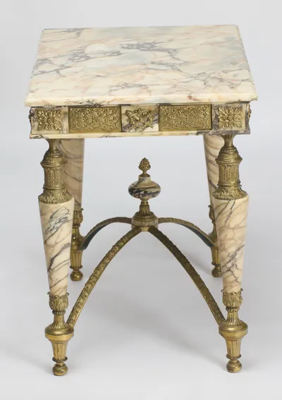 The veined top and the end frieze together, a small trophy mount centred between berried lattice panels.