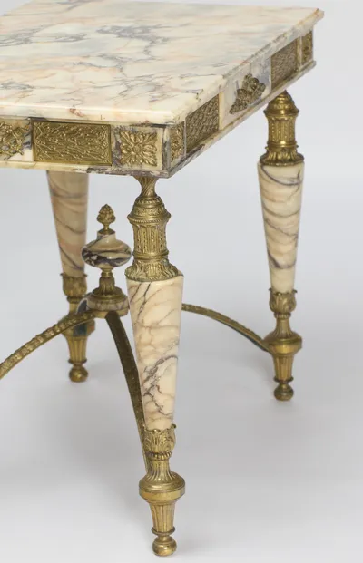 Frieze panels meeting at a corner rosette above one leg, the stretcher and finial beyond.