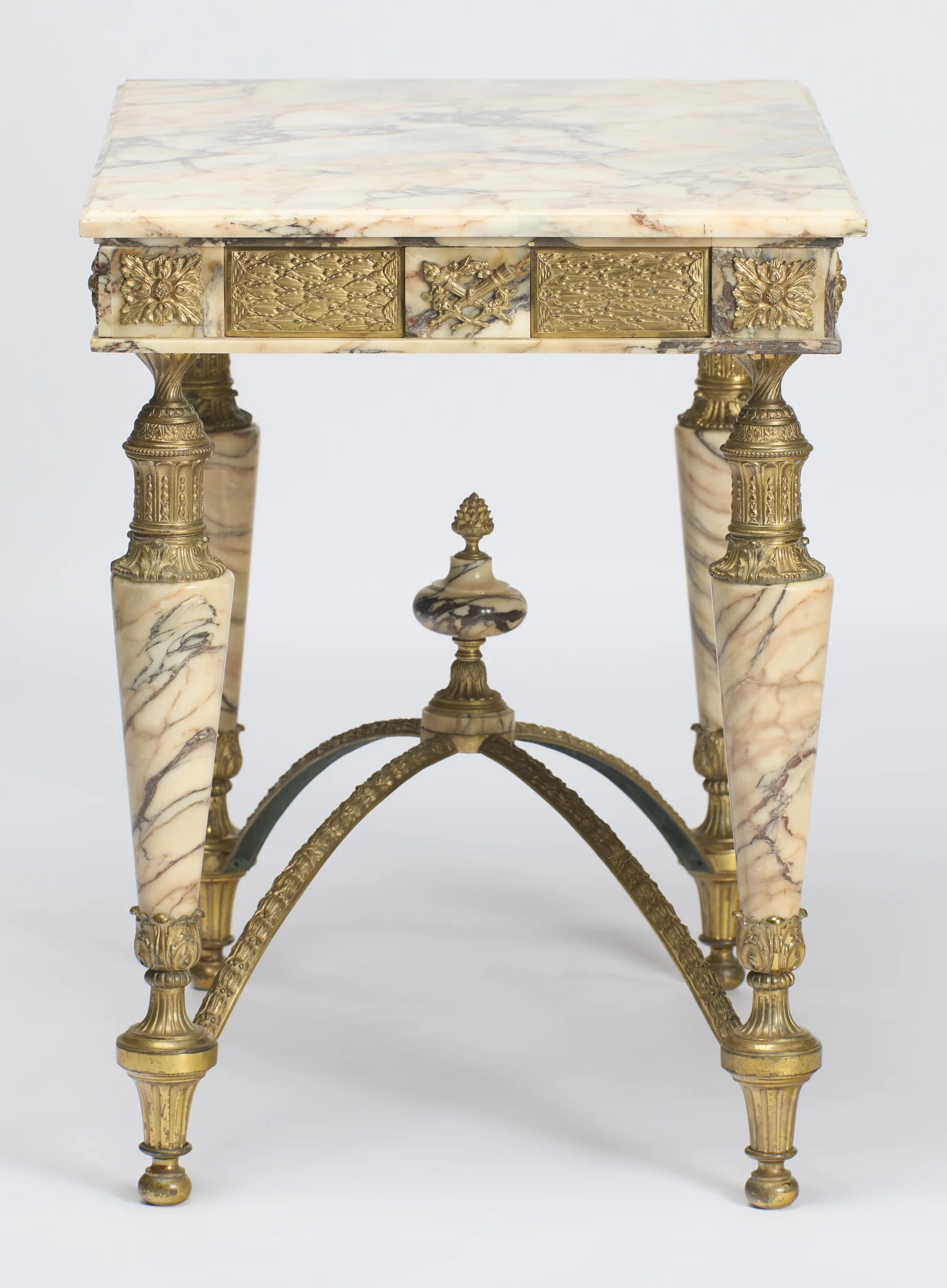 The short side square on, marble tapers falling to fluted gilt feet either side of the arched stretcher.