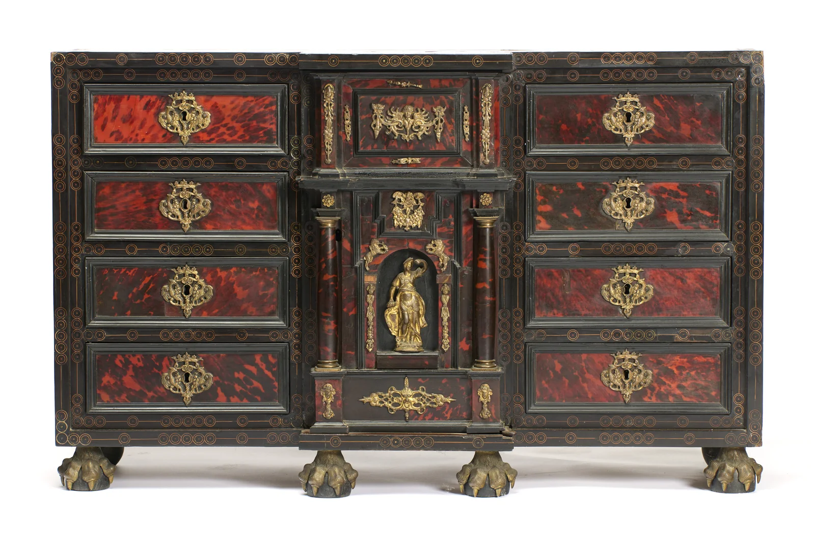 Eight mottled red panels with gilt escutcheons flank the central architectural compartment and its gilt figure, the whole raised on metal paw feet.