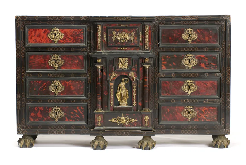An ebonised and inlaid cabinet with tortoiseshell-effect panels, gilt-metal mounts and central figural niche
