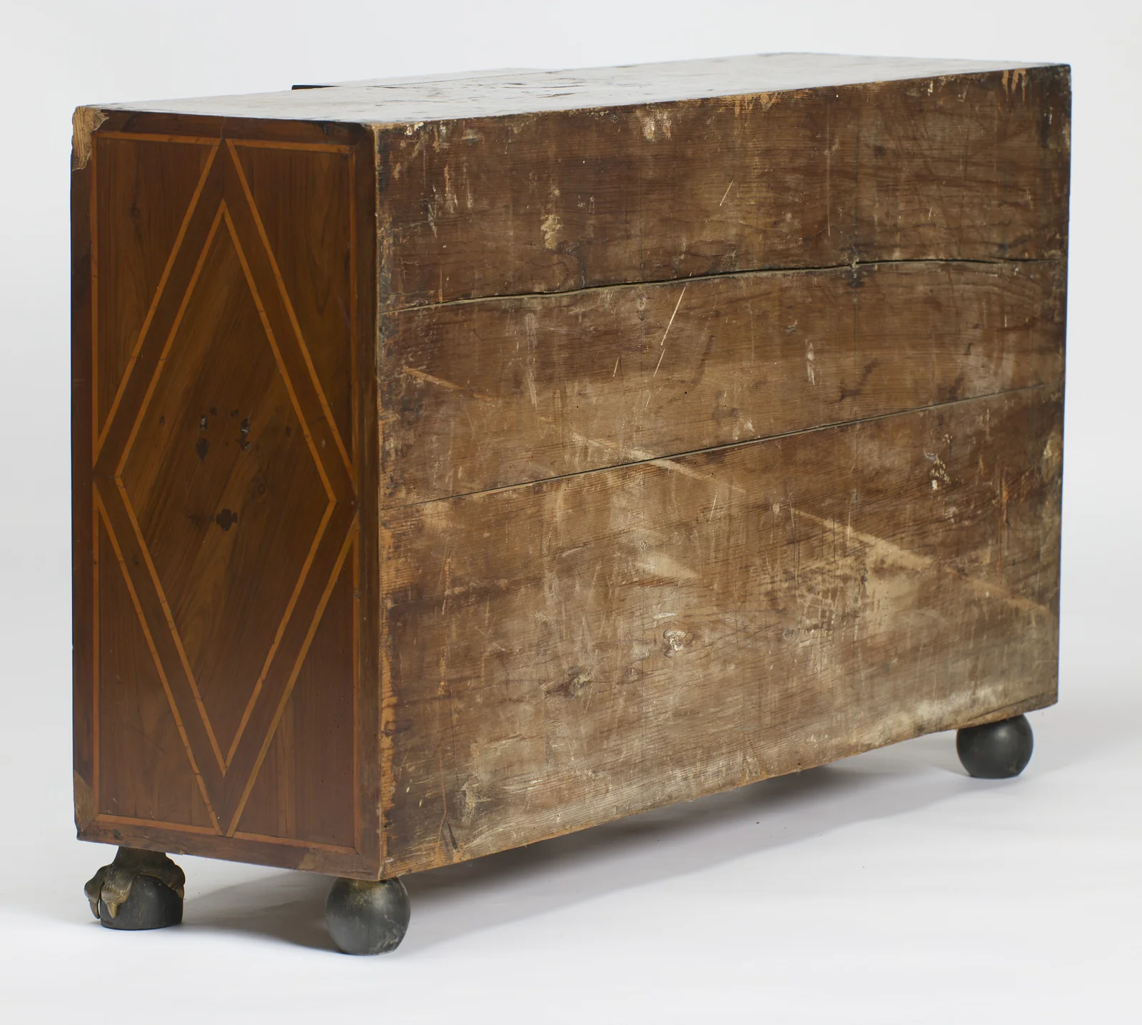 The boarded back meets the diamond-inlaid side panel at a clean corner, with the rear ball feet showing below.