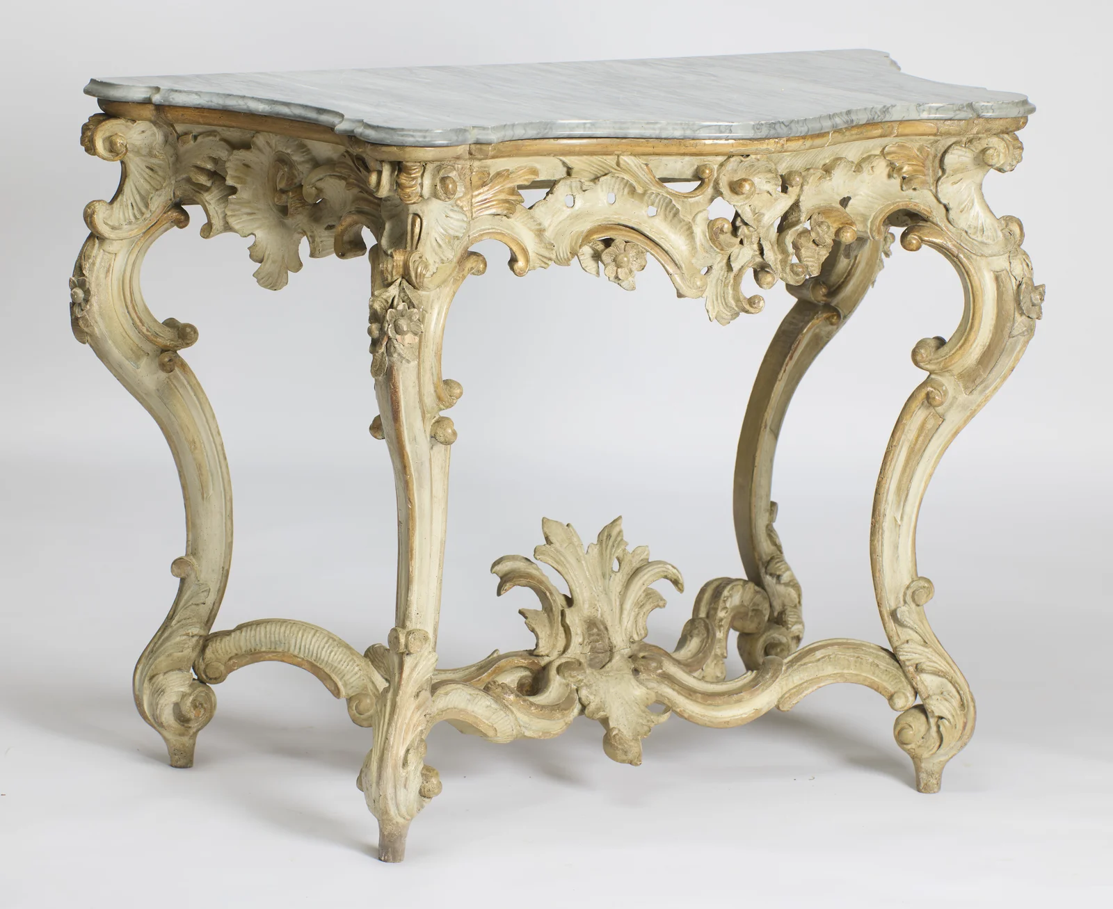 The table from the left, with the pierced apron and the sweep of the stretcher read in depth.