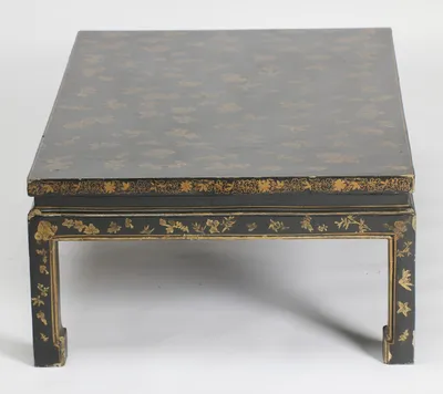 The short side, decorated to match the long sides, with a gilt-lined panel running down each leg to the foot.