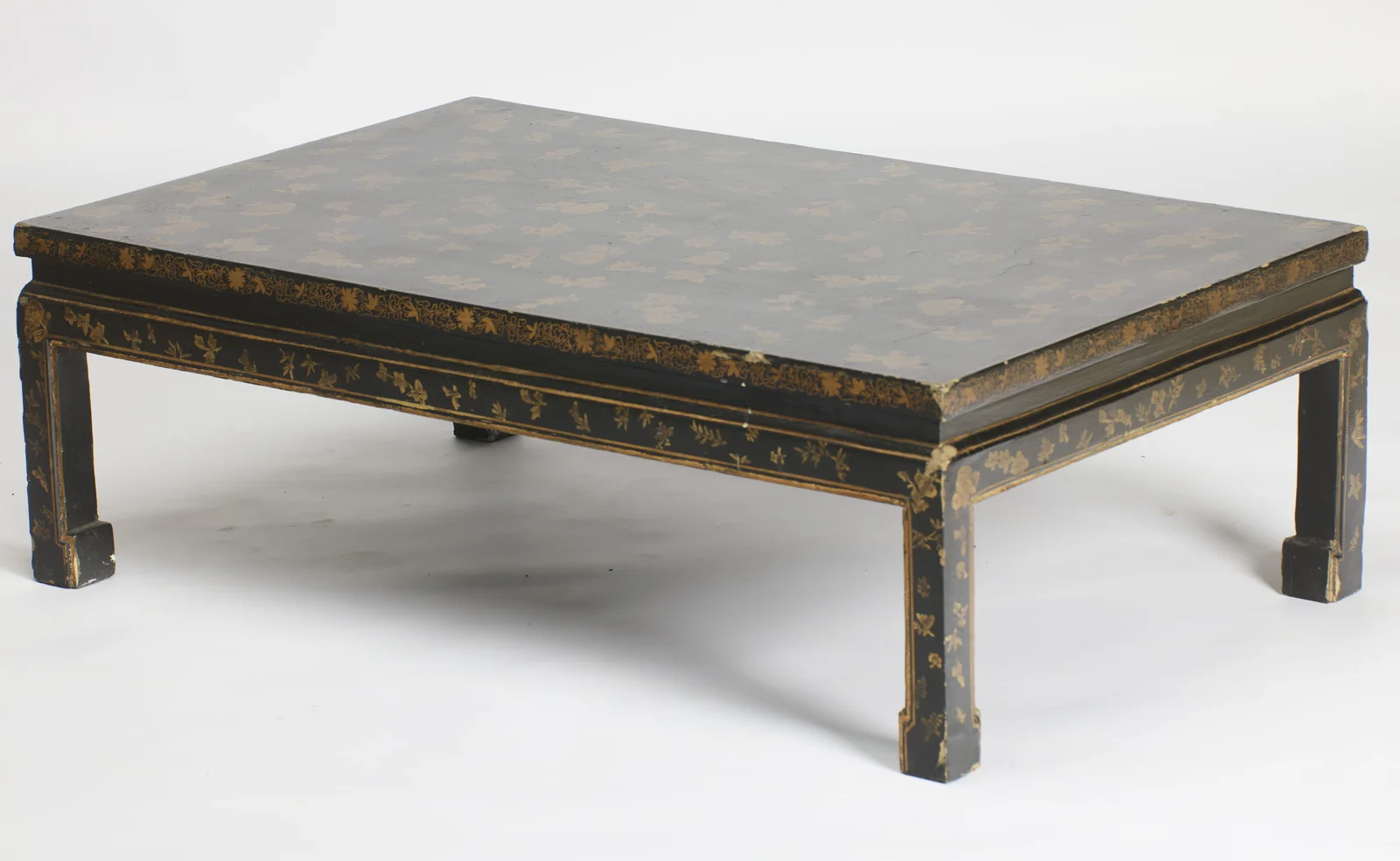 The top and two decorated sides together, the scrolling edge border and apron sprigs carrying unbroken around the corner.