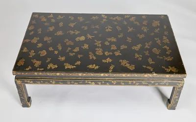 Gilt flower sprays and leafy sprigs scattered over the black ground, with butterflies and a dragonfly among them, all within a single gilt line border.