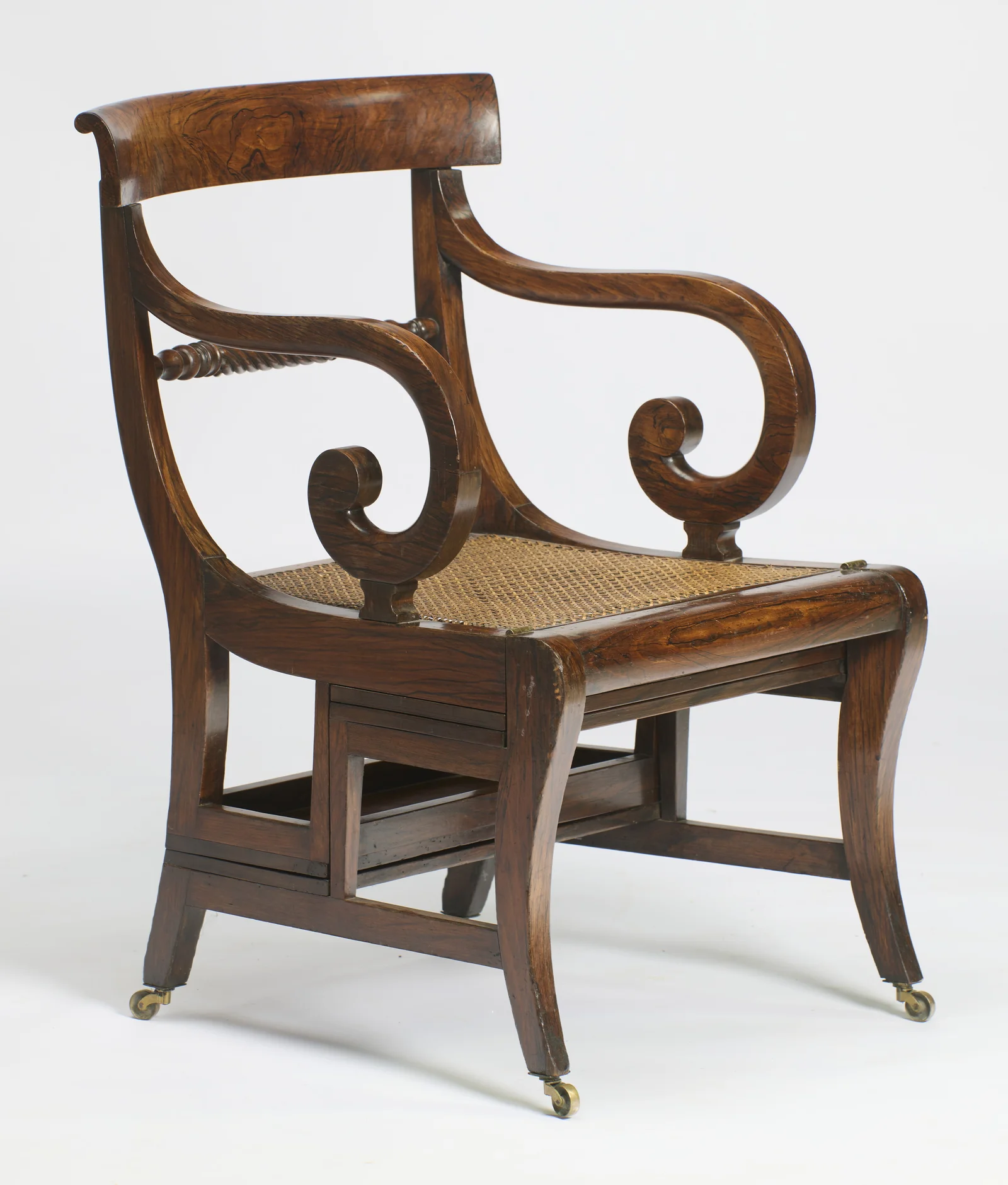 The cane seat seen three-quarter on, the seam of the folding frame running beneath the seat rail.
