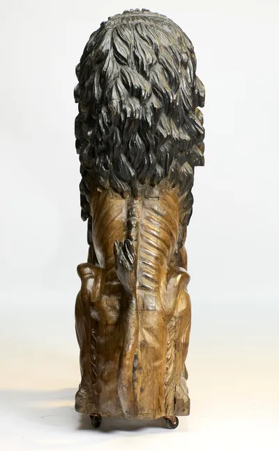 The mane descends to mid-back and the tail rises between the haunches, its tuft laid against the spine.