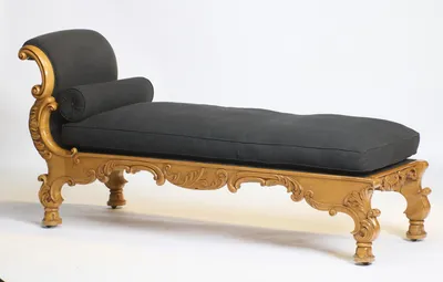 The carved apron and bracket legs run the full length of the seat, with the scrolled head end rising beyond.
