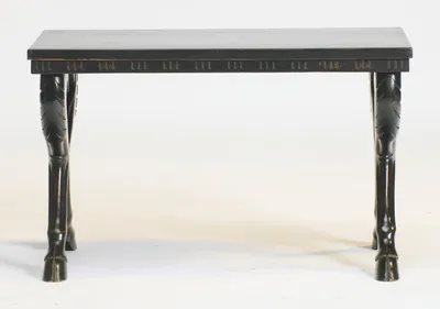 Straight on, the long frieze shows evenly spaced groups of short vertical flutes, the legs curving outward to hoofed feet at each corner.