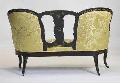 Gilt character-style marks decorate the reverse of the pierced splat, between two fully upholstered outside backs.