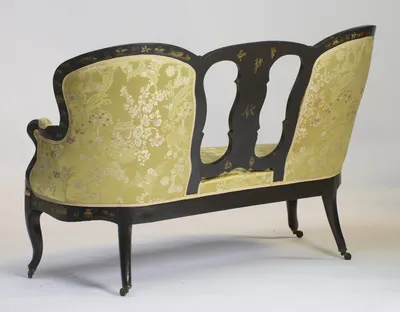 The upholstered outside back and swept rear legs, with the gilt marks visible on the splat.