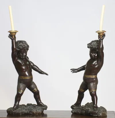 The slight turn shows the rounded modelling of the torsos and the deeply carved hair swept back from each brow.