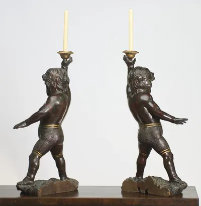 The figures lean into their stride, the outswung arm reaching back with fingers spread and the punched trunks continuing round.