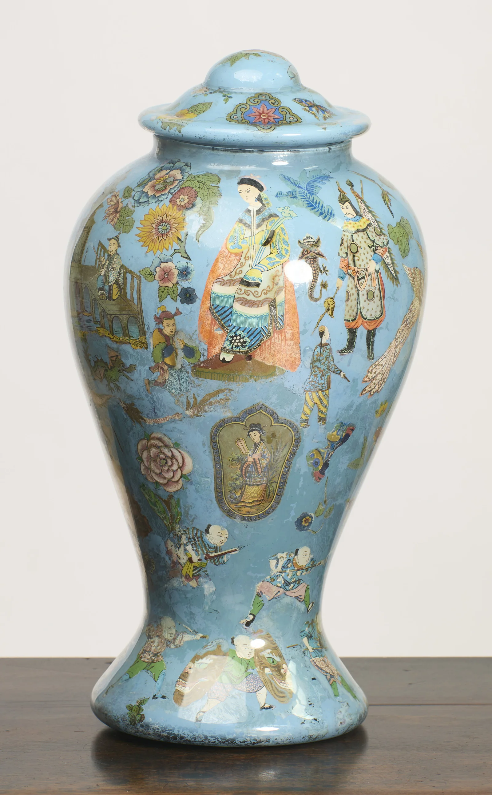 A lady seated in an orange robe holds the shoulder of the vase, a standing warrior beside her and a lobed cartouche of a female musician on the lower body.