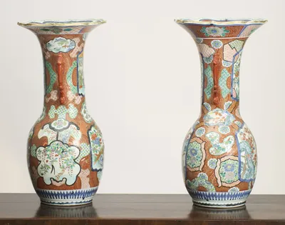 The scroll handles in profile, with the panelled decoration of flowers, birds and landscape vignettes carrying right around the neck and shoulder of each vase.