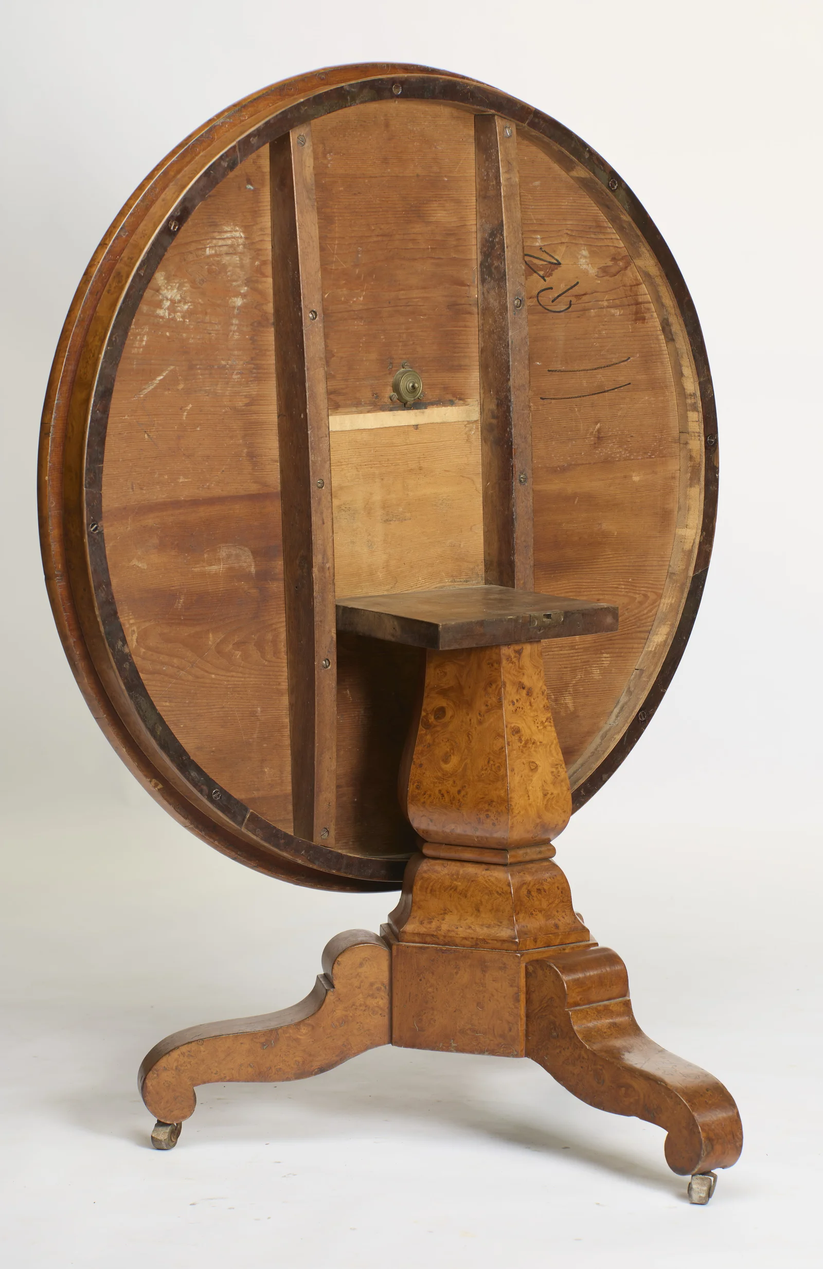 Boarded underside with two shaped bearers, a round metal catch, exposed screws and old black scrawled marks.