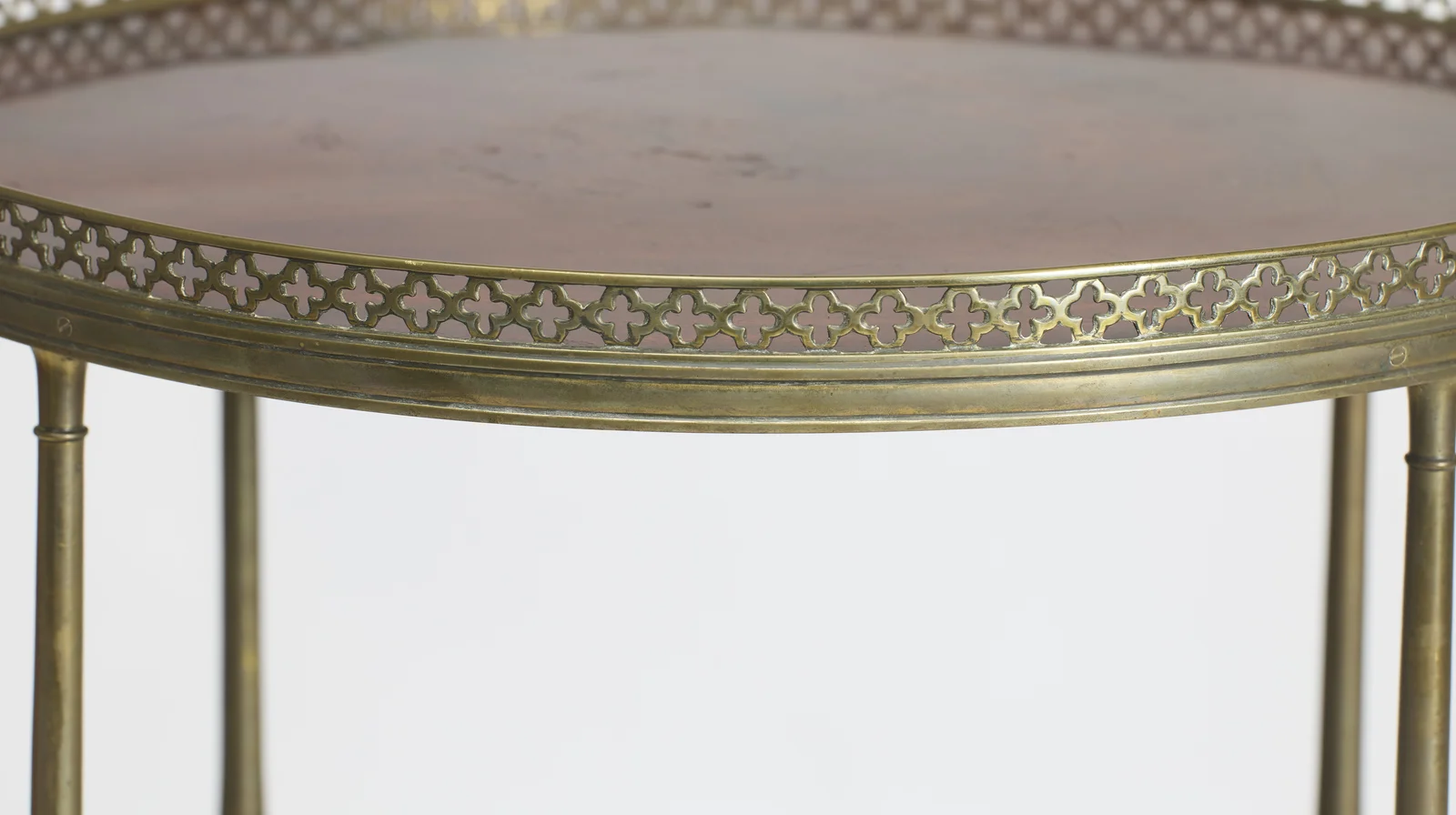 A pierced quatrefoil gallery encircling the well-figured top, with faint surface marks visible toward the centre.