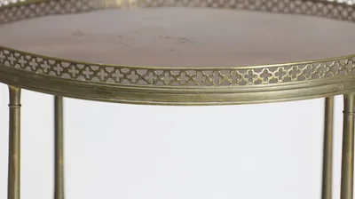 A pierced quatrefoil gallery encircling the well-figured top, with faint surface marks visible toward the centre.
