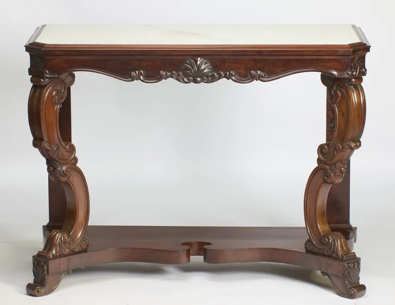 Carved console table with white marble top, shell-centred apron and S-scroll supports