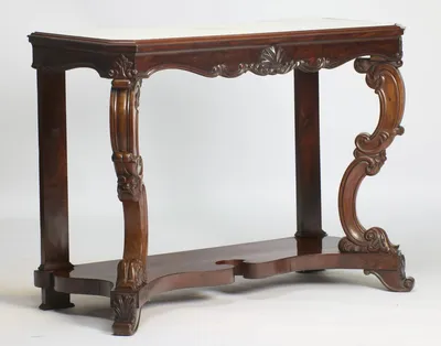 The angled view shows the depth of the moulded top edge, the canted corner of the frieze and the sweep of the front supports against plain square rear pillars.