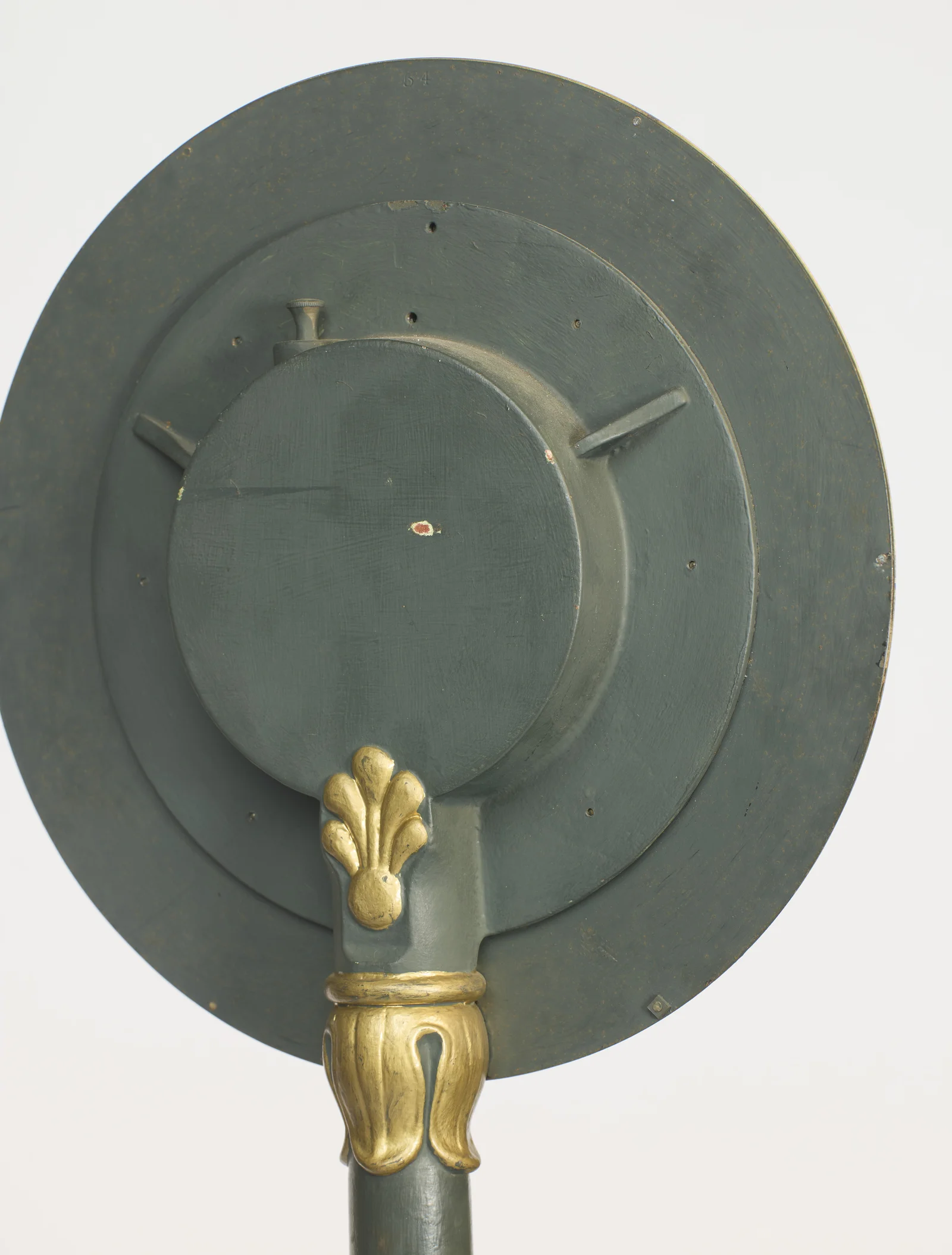 The gilt palmette and leaf-cast collar where the column meets the back of the dial housing.