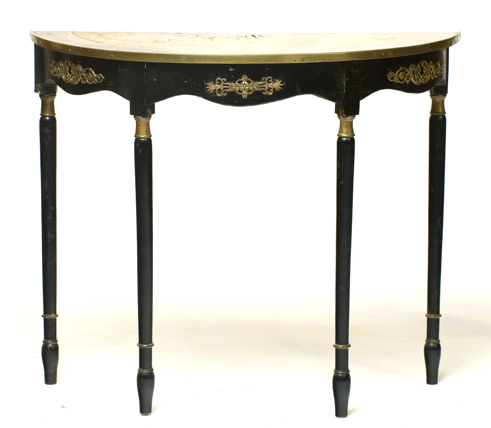 The brass-bound top above a shaped black frieze applied with pierced gilt-metal mounts, raised on four slender ring-turned legs with gilt collars.