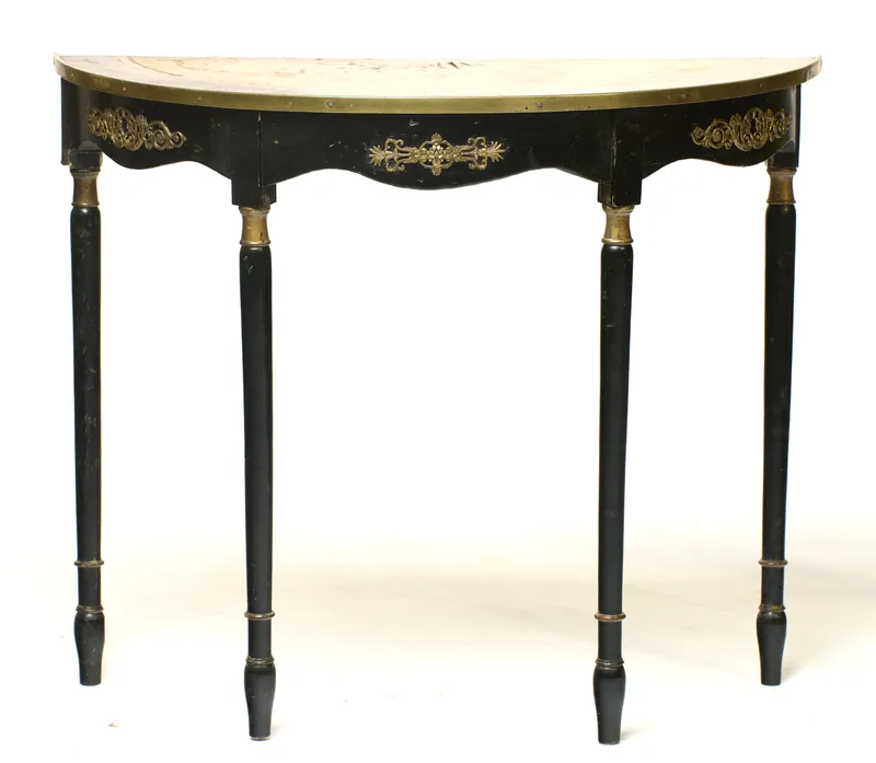 An ebonised and gilt-metal mounted demi-lune console table