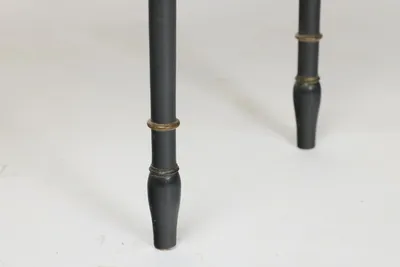 Gilt-lined ring turnings above swelled tapering feet, with rubbing and small losses to the black finish.