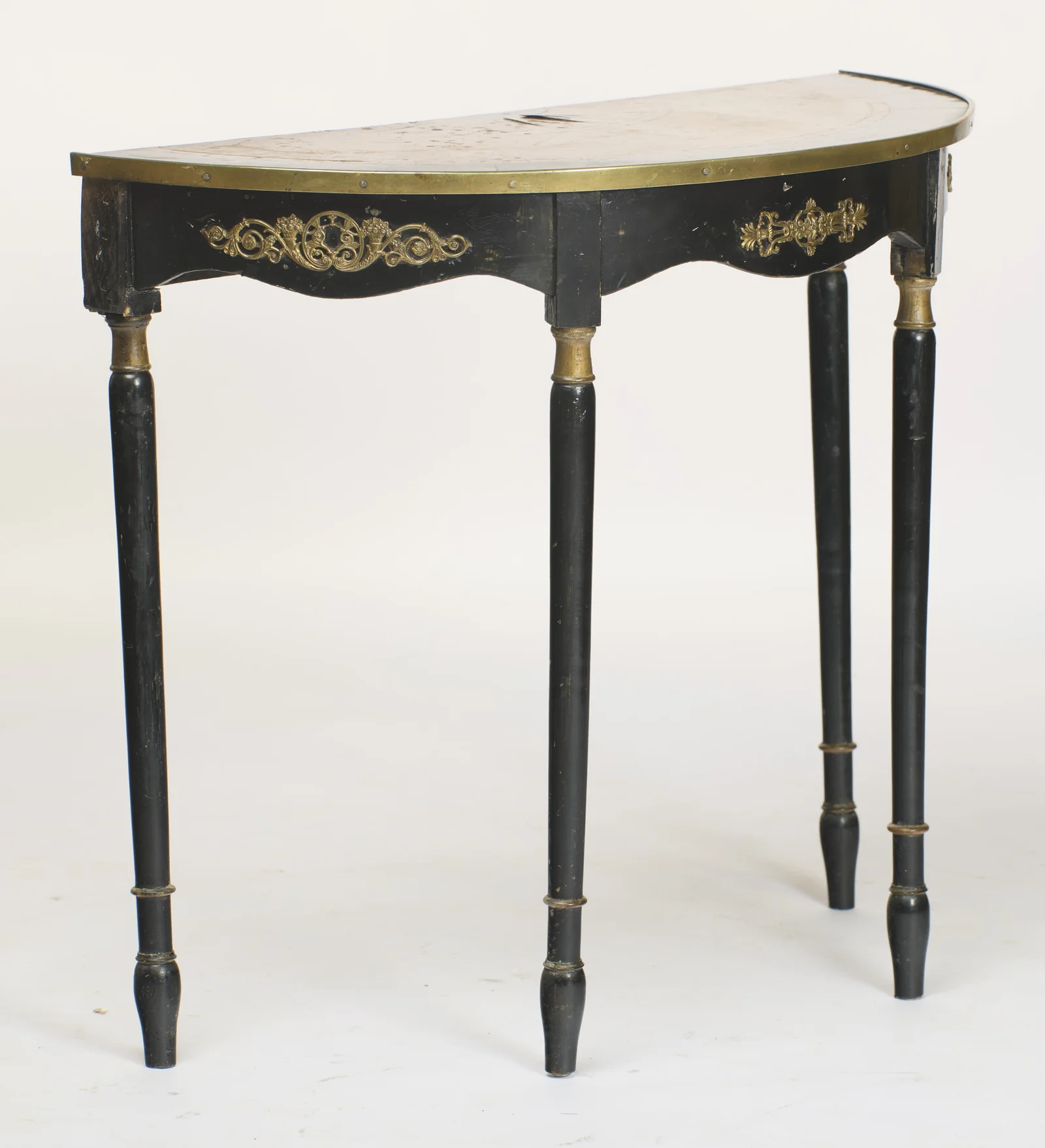 The bowed frieze sweeps around the curve, carrying its gilt mounts, with the legs set square beneath the flat back edge.