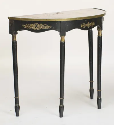 The bowed frieze sweeps around the curve, carrying its gilt mounts, with the legs set square beneath the flat back edge.