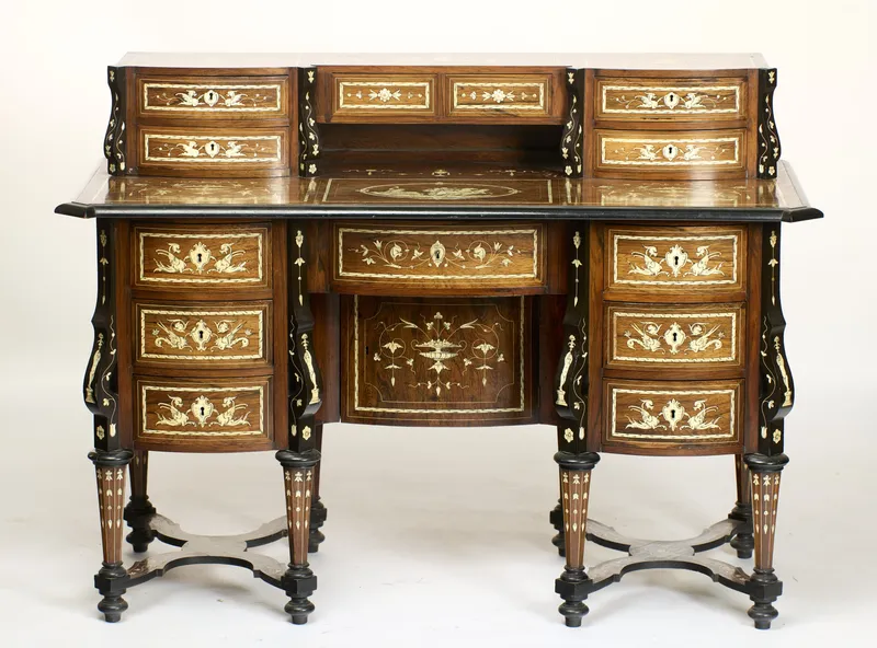 A profusely inlaid and ebonised kneehole writing desk with drawer superstructure