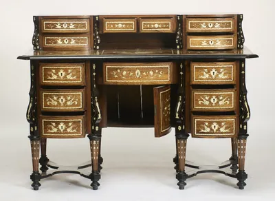 The kneehole cupboard door stands open and several drawers are drawn, showing the plain unlined interiors; light shows through gaps between the boards at the back of the kneehole.