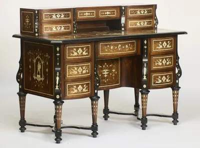 The bow of the drawer fronts and the depth of the pedestals, with the side panel inlaid with an armed figure standing under a columned arch hung with ribbon swags.