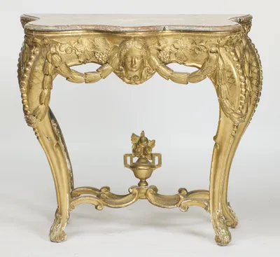 The complete console with its urn finial in place, the shaped marble sitting on a frieze hung with husk swags between the cabriole legs.
