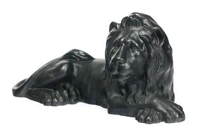 The head turned above outstretched forepaws, the mane in long waved strands down the chest.