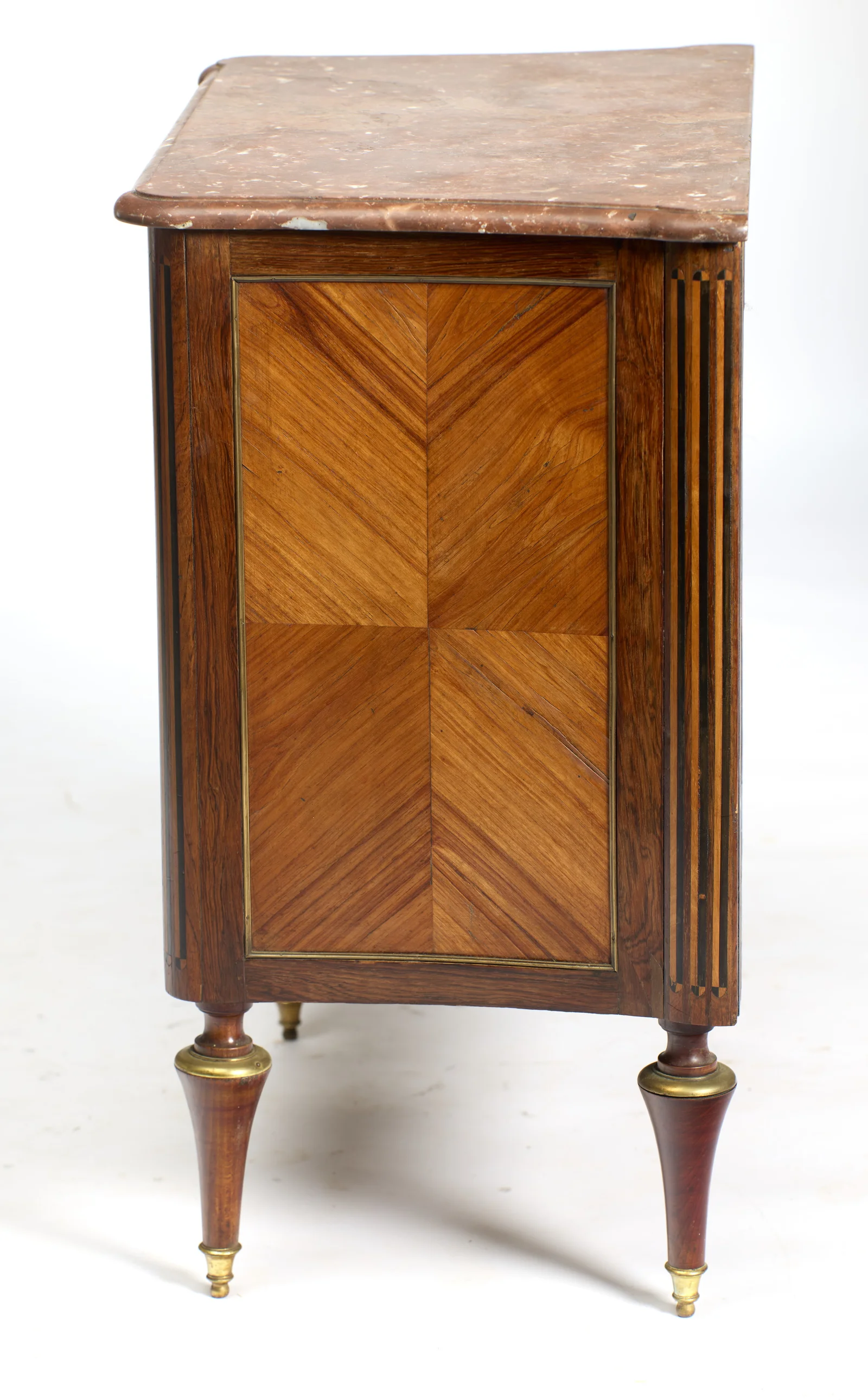 The matching quartered panel on the other face; a chip to the front corner of the marble is visible at the left.