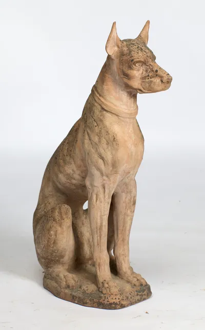 The full figure sits erect with the head carried high, the weathered surface running from buff to near black.