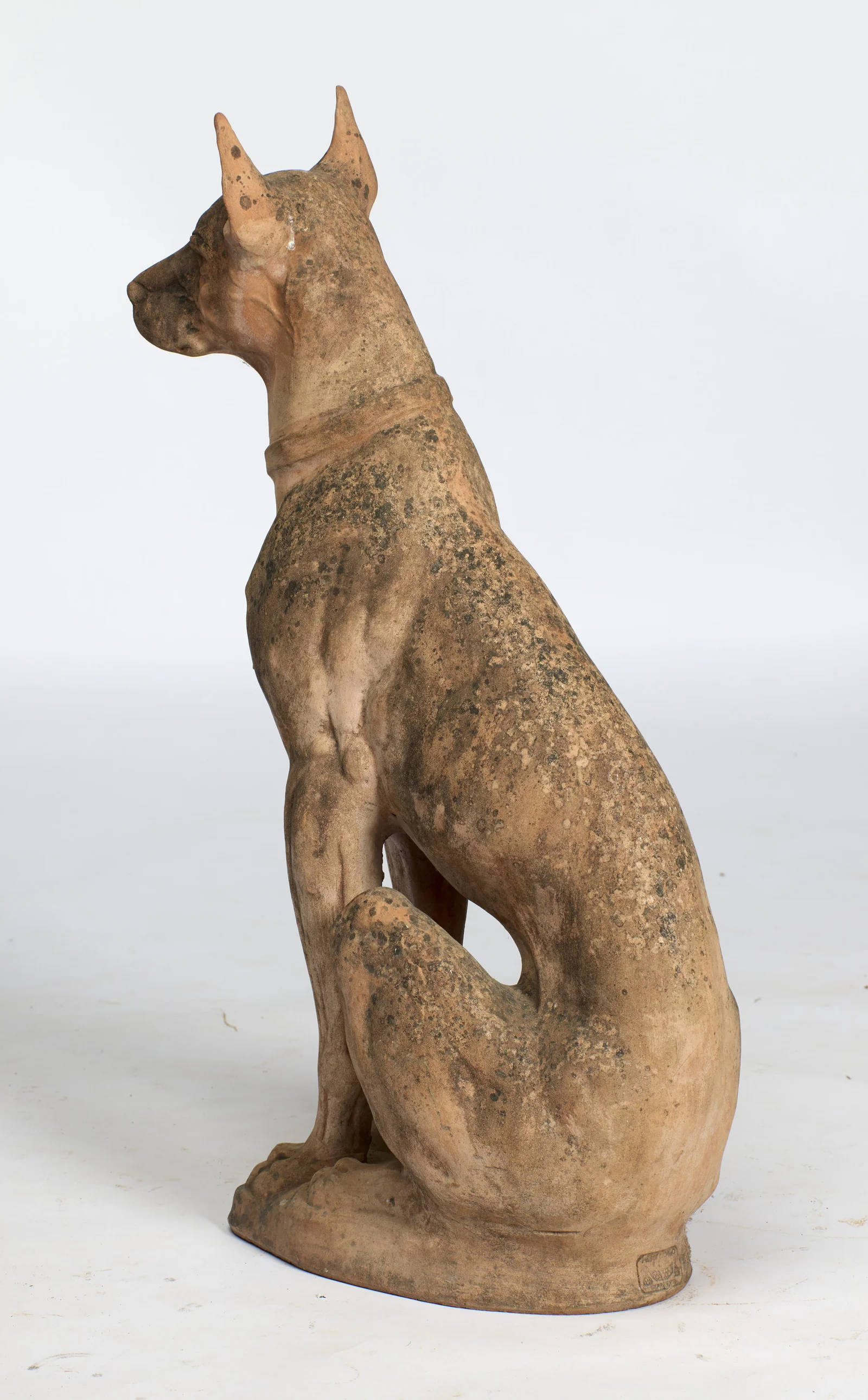 From behind the shoulder the tail curls round the haunch, the impressed cartouche just visible on the base.