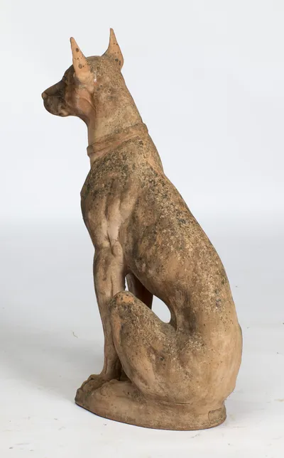 From behind the shoulder the tail curls round the haunch, the impressed cartouche just visible on the base.