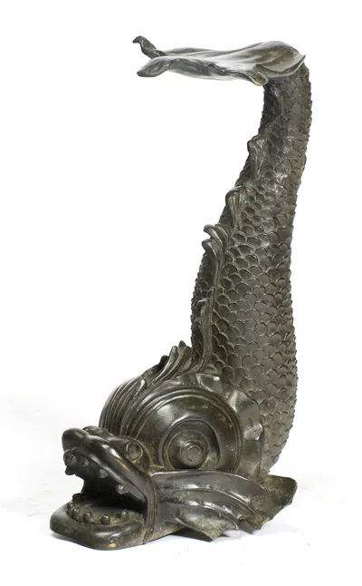The underside of the leaf and the hooked tail tip carry over the swept fins, eye volute and open jaw below.